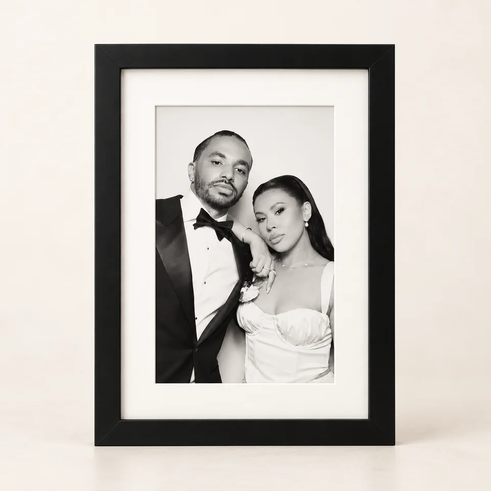 Black photo frame with a white mount and a black and white wedding portrait.