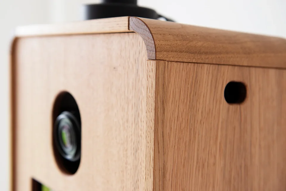 Close-up of the Icon Booth’s oak grain and rounded joinery.