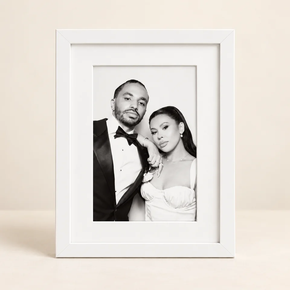 White photo frame with a white mount and a black and white wedding portrait.